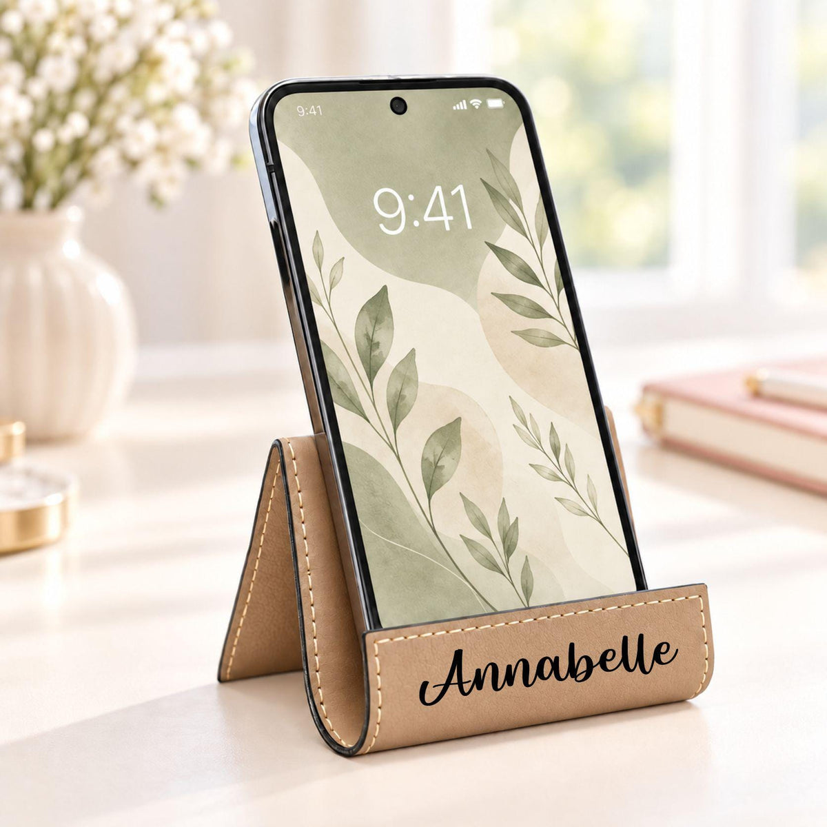 Light brown phone stand engraved with the name Annabelle