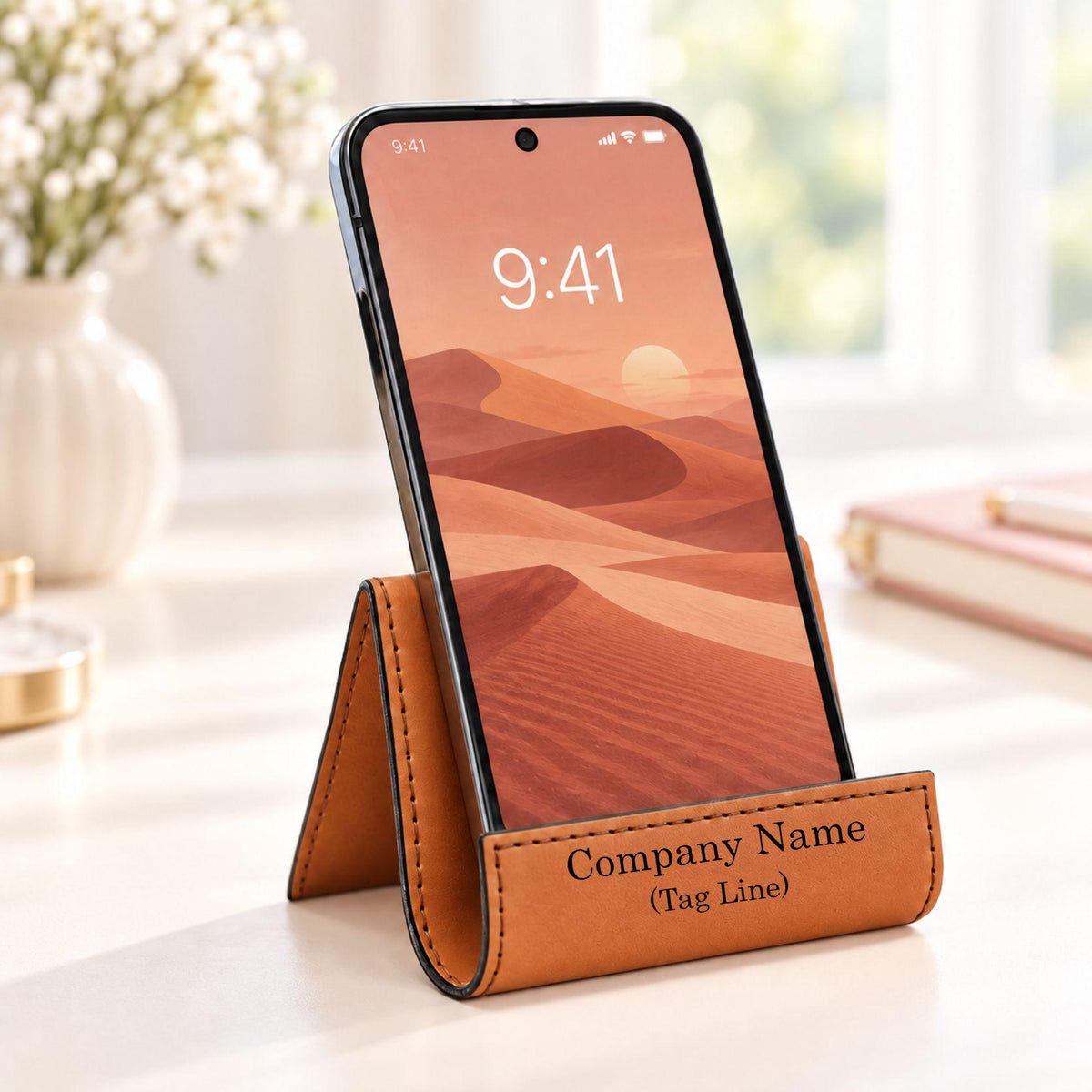 Rawhide phone stand engraved with a company name and tag line