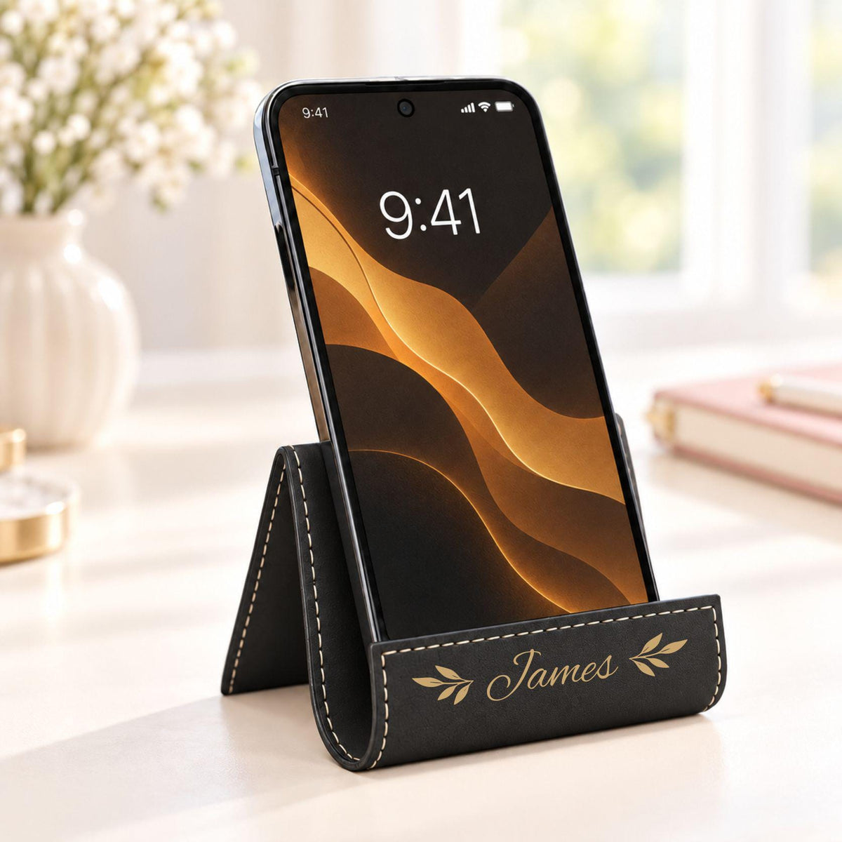 Black phone stand with gold engraving, name James with leaf design
