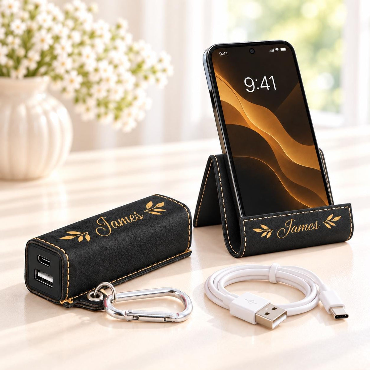 Black phone stand and power bank set with gold engraving, name James