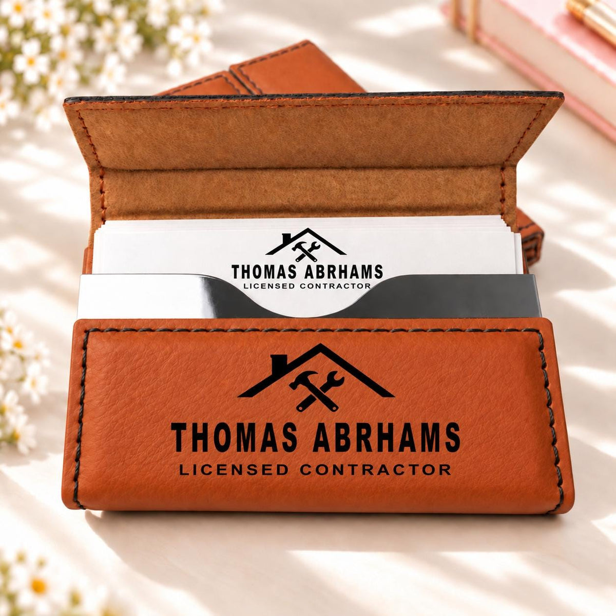 Rawhide business card holder engraved with a contractor design, name and title